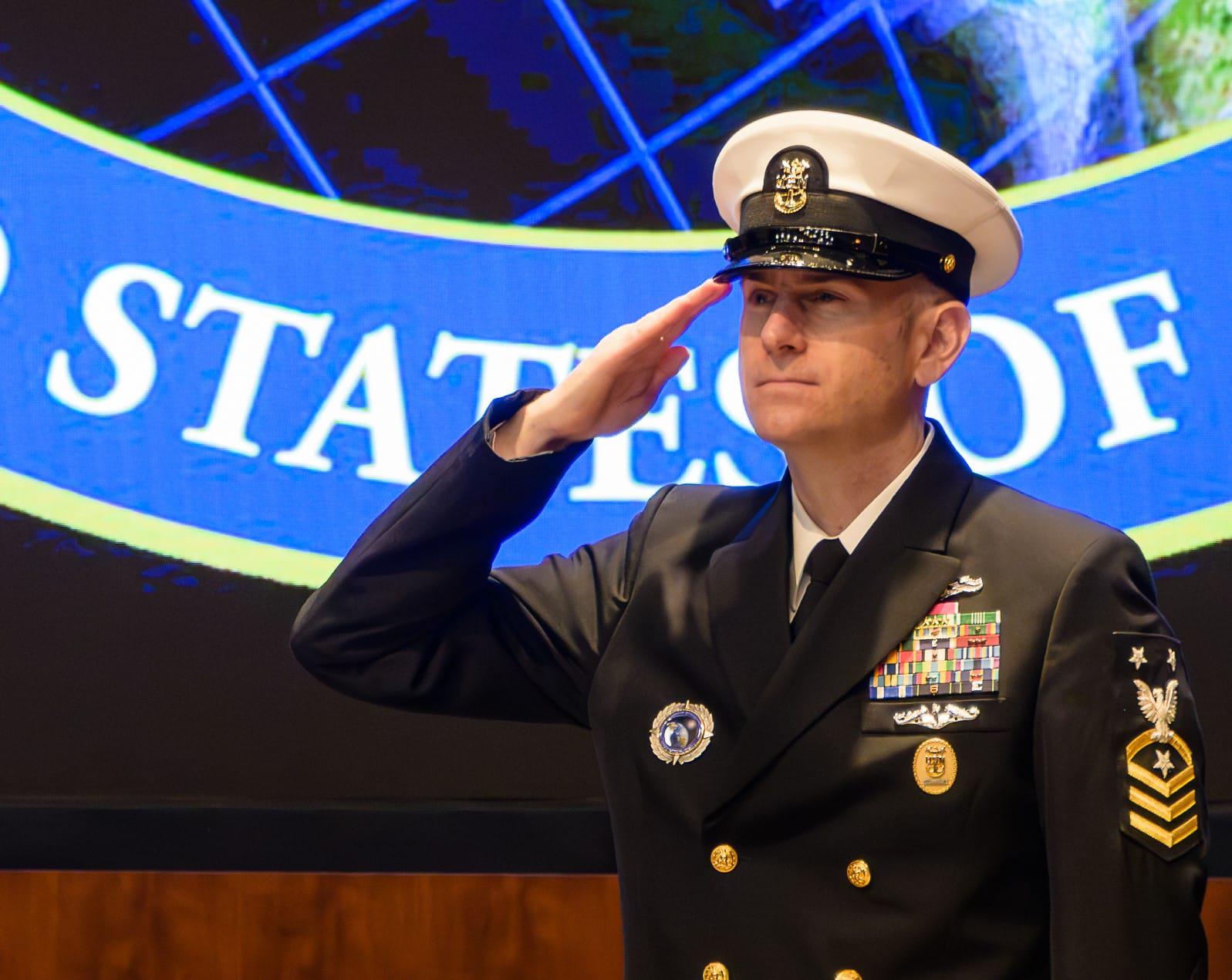 U.S. Navy Command Master Chief Jason T. Reynolds salutes as the new senior enlsited leader during a change-of responsibilities cermony at NGA Washington. (Photo by NGA's Office of Corporate Communications)