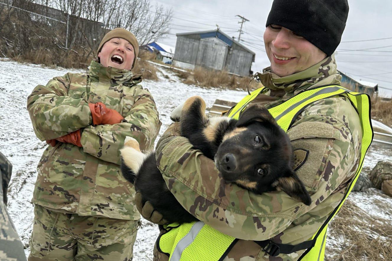 Alaska Organized Militia members assigned to Task Force Bethel interact with a puppy at Kipnuk, Alaska, during post-storm recovery efforts for Operation Halong Response, Oct. 21, 2025. (Courtesy photo)