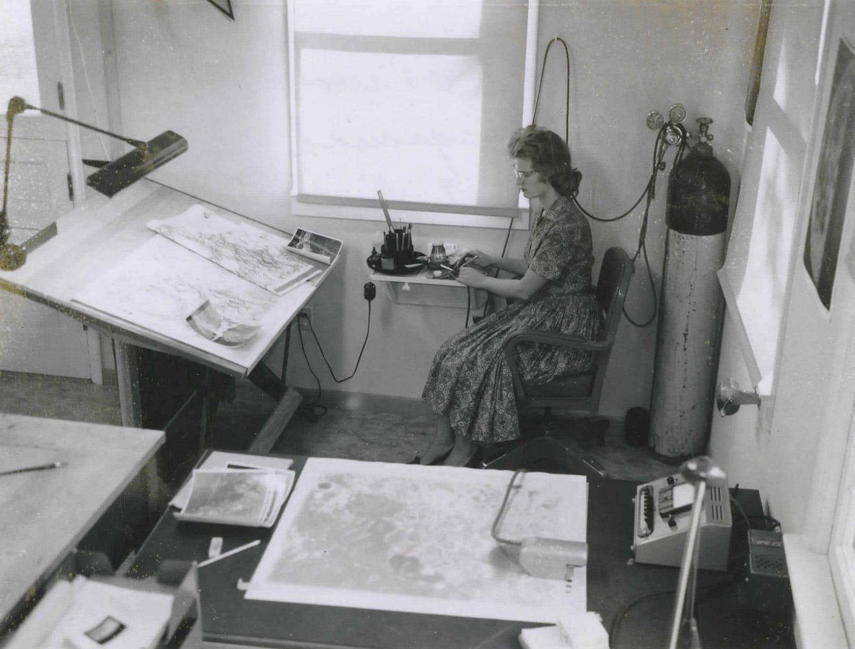 Patricia Bridges captioned this photo of her in the ACIC office at Lowell Observatory: “Me in my corner in the foreground and my drawing table on the left. My tank of air in the corner.” Photo courtesy of Patricia Bridges/Lowell Observatory.