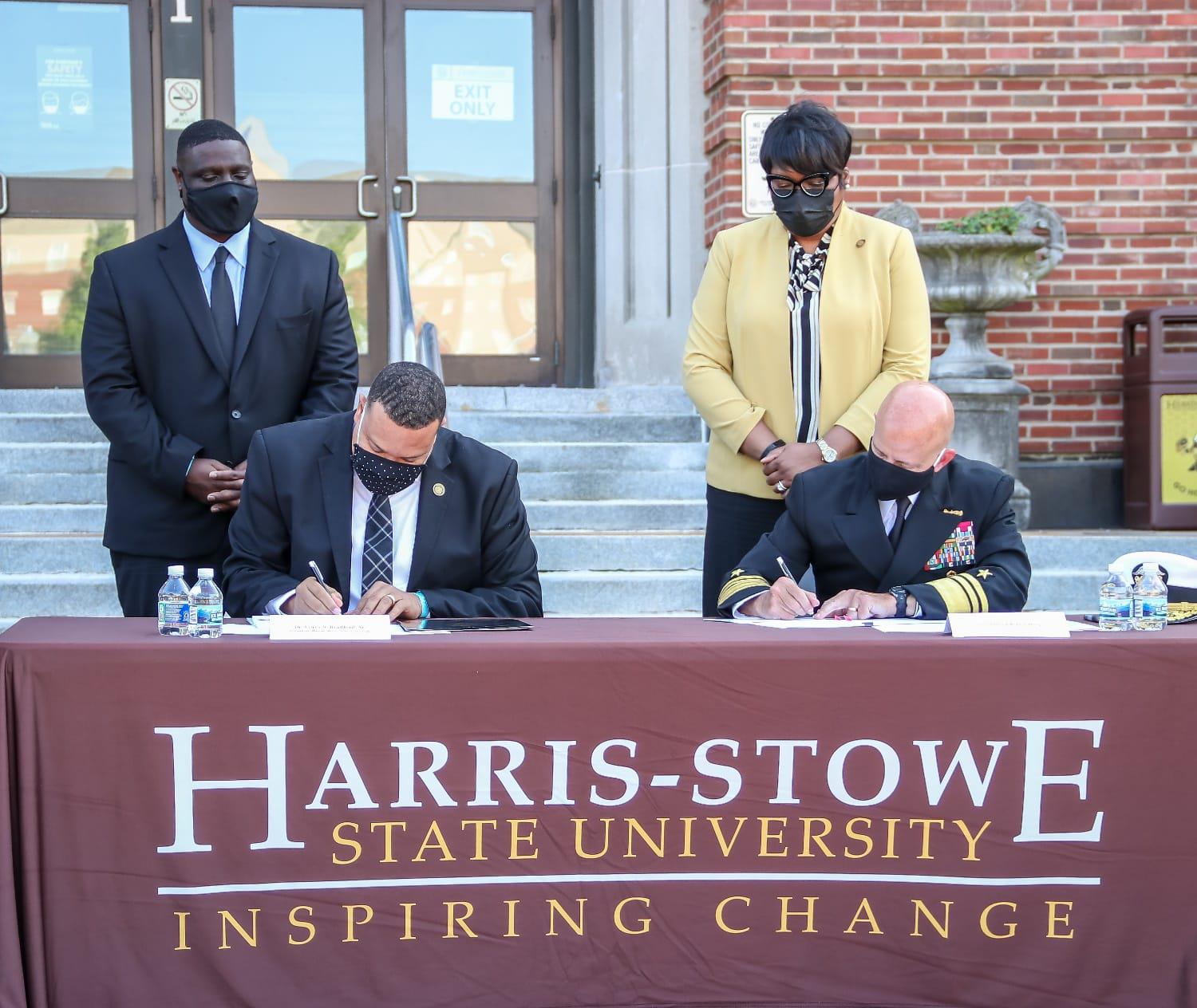 ['(Left to right) Harris-Stowe State University President Corey S. Bradford Sr., Ph.D., and Vice Adm. Robert D. Sharp, NGA director, sign an agreement during a ceremony at the university in St. Louis, Sept. 21. Photo courtesy of HSSU.']