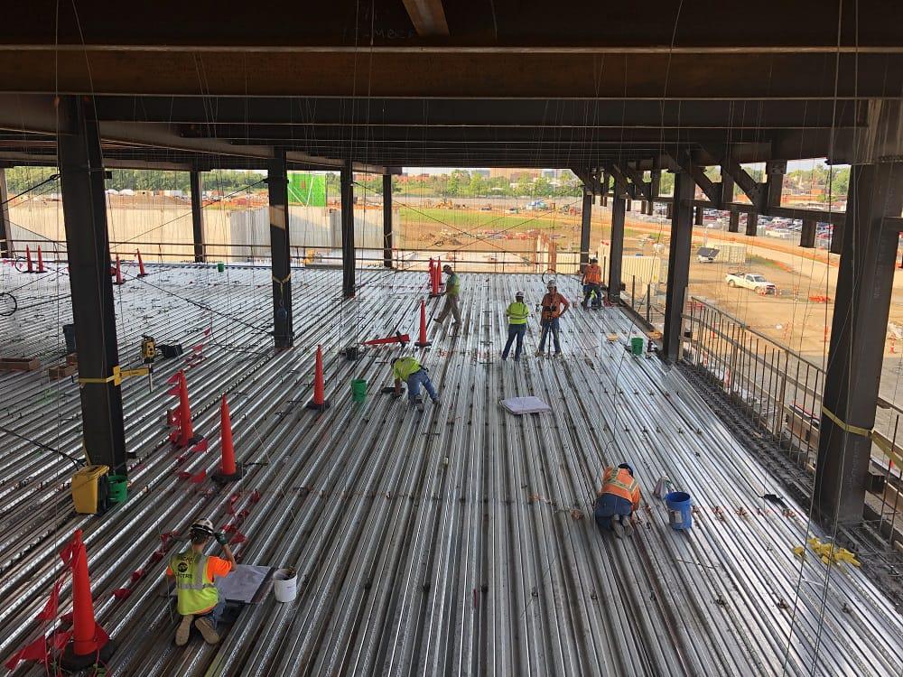 Construction workers prepare to install the slab-on-metal-deck on the second level of the main operations building. Photo courtesy of the U.S. Army Corps of Engineers.